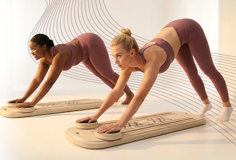 Two women in pike position on yunamuv boards